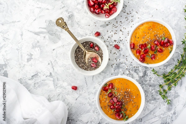 Fototapeta Detox and healthy breakfast with seasonal fruits, milk, chia seeds, pomegranate   herbs on a gray marble background. Top view. The concept of  organic natural food.