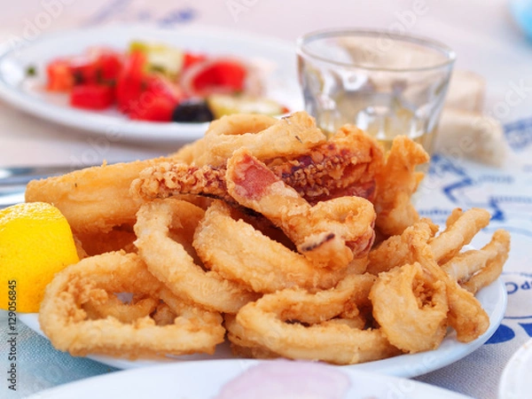Obraz Portion of fried squid (or calamari). Greek style. Salad and win