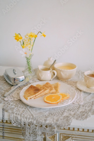 Fototapeta Rustic Breakfast with Crepes and Orange Cream  Cozy Morning Atmosphere