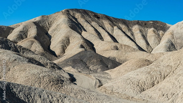 Fototapeta The image captures the undulating hills with fascinating textures and colors, exhibiting the raw beauty of nature's formations in a serene and captivating landscape.