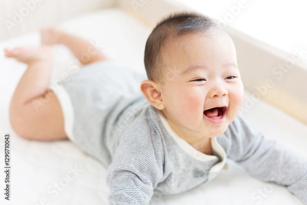 Obraz Happy baby playing on bed