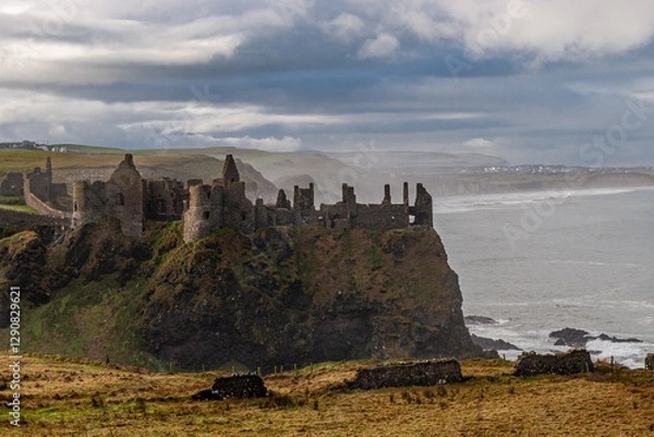 Fototapeta Discover the enchanting ruins of an ancient Dunluce coastal castle, set against a serene seascape Ireland Europe