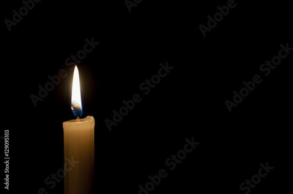 Fototapeta Candle on a black background