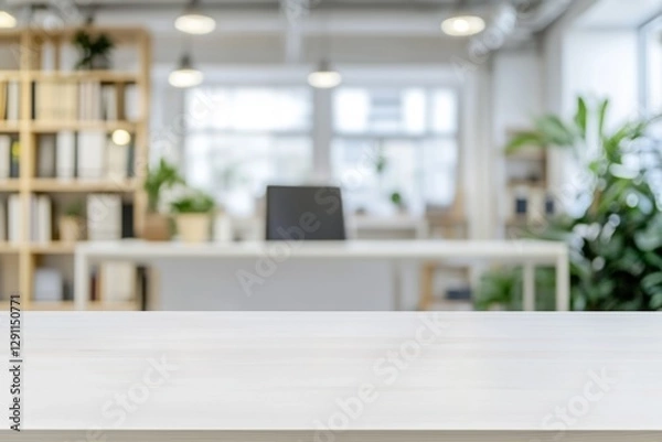 Obraz Bright white rectangular wooden table with overhead lighting and blurred office background featuring desk, bookshelves, and plants
