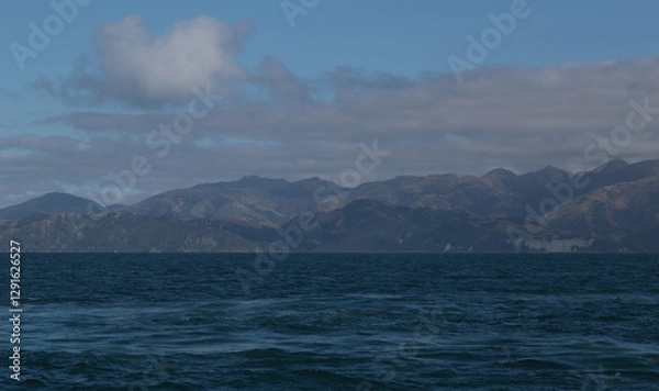 Obraz Delightful sea landscape with blue surface of the water, magic feather clouds on the sky over mountain in Kaikoura,New Zealand