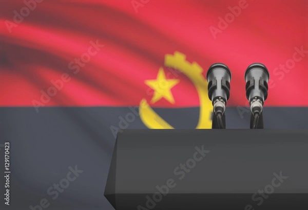 Fototapeta Pulpit and two microphones with a national flag on background - Angola