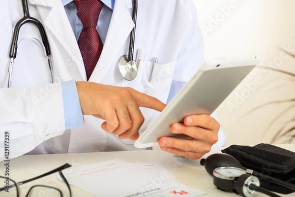 Obraz Doctor holding a tablet