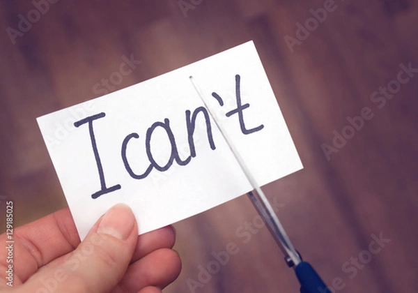Obraz Success self motivation concept. Hand cutting phrase I can not cut by scissors and became I can