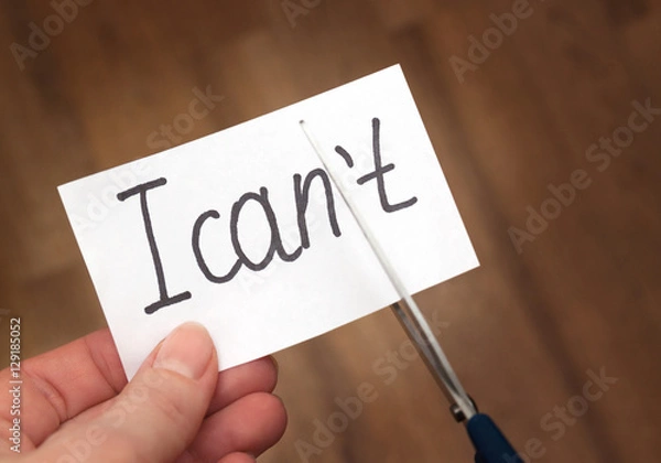Obraz Success self motivation concept. Hand cutting phrase I can not cut by scissors and became I can