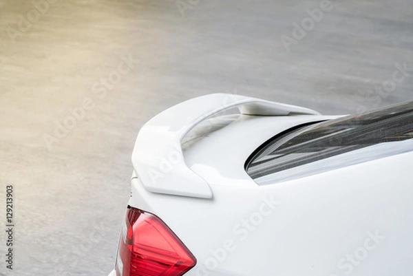 Obraz car part ; Close up detail of a custom racing carbon fiber spoiler on the rear of a modern car with copy space
