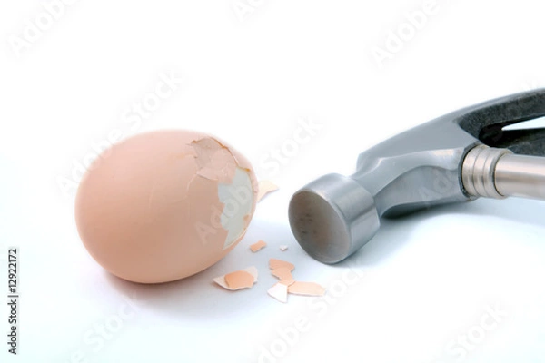 Fototapeta Egg crushed by hammer