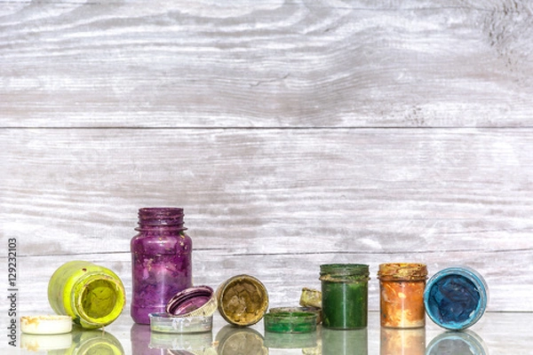 Fototapeta Multicolored plastic cans with paints. Artist workplace background. Old dirty Paints background. Colorful artist palette. Creativity, visual art concept. Art and craft.