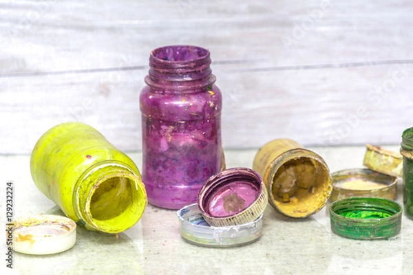 Fototapeta Multicolored plastic cans with paints. Artist workplace background. Old dirty Paints background. Colorful artist palette. Creativity, visual art concept. Art and craft.