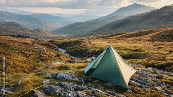 Fototapeta Serene Mountain Camping: A Lone Tent in a Vast Highland Landscape