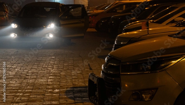 Obraz Nighttime Parking Lot – Headlights and Shadows