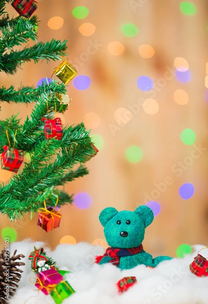 Fototapeta Snowman and gift boxes on bokeh background