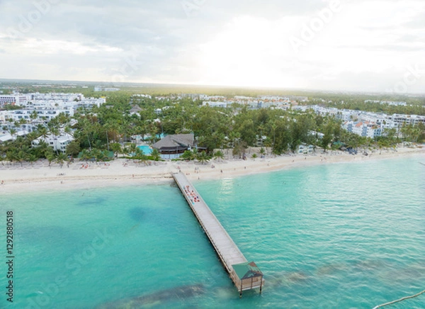 Obraz A beautiful beach with a pier and a hotel in the background