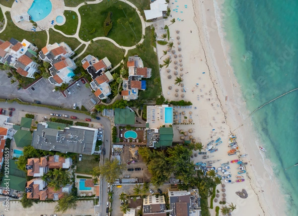 Obraz A beach with a hotel and a pool