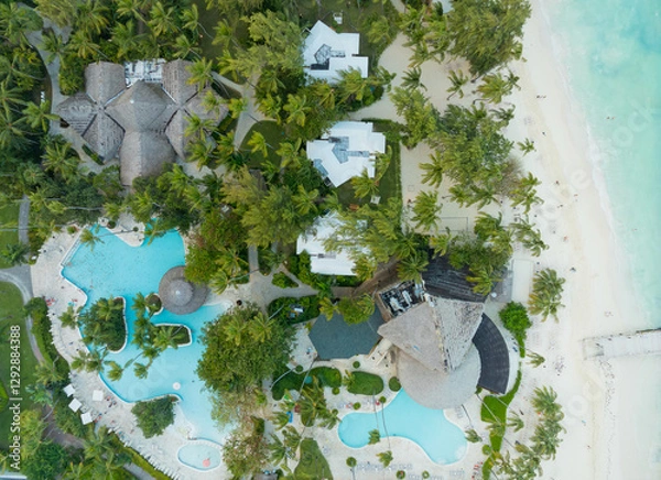 Obraz A beach resort with a pool and a hotel