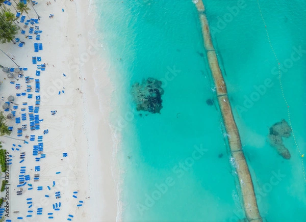 Obraz A beach with many people and chairs, and a blue ocean