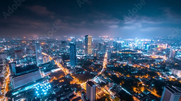 Obraz Futuristic Urban Skyline with Illuminated Streets