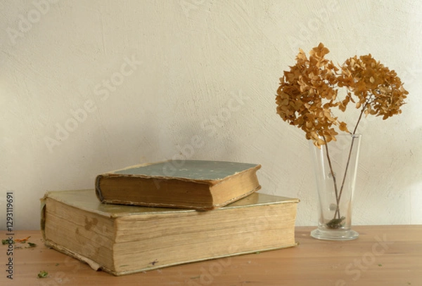Obraz Vintage books and dried flowers on wooden table