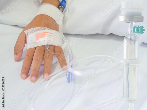 Fototapeta Saline intravenous (iv) drip on children hand in hospital. Health care and Medical equipment concept.