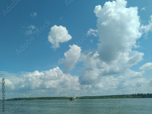 Fototapeta On a river summer fishing trip on a cloudy day.
