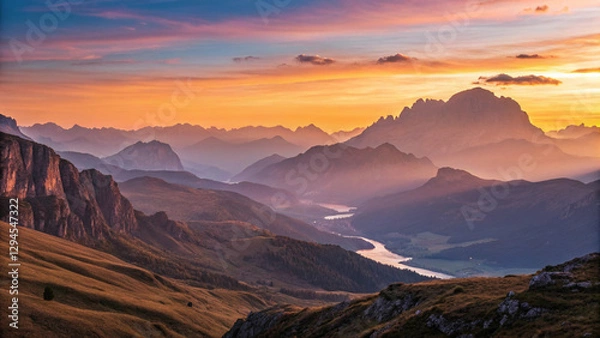 Fototapeta A breathtaking mountain landscape at sunset, with the sun casting a warm, golden glow over the rugged peaks