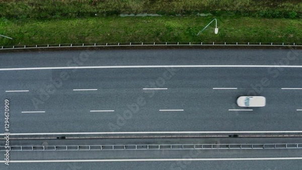Fototapeta Video filming from a bird's eye view of car traffic on a section of the road. Top view, video shooting from a quadrocopter