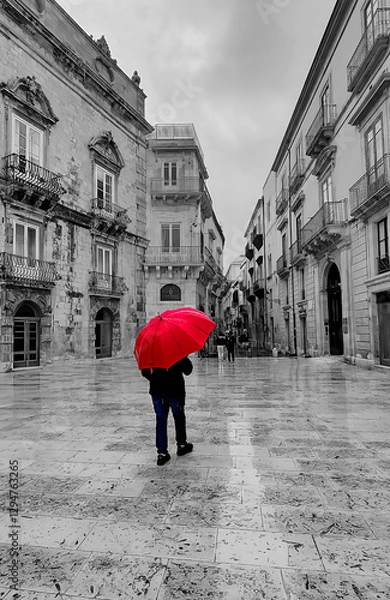 Obraz Man walking through Italian plaza with red umbrella 