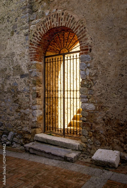 Obraz Ancient doorway lit up with golden light