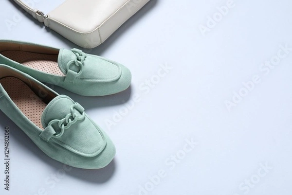 Fototapeta Pair of stylish shoes and bag on white background, above view. Space for text