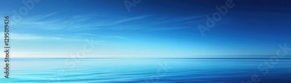 Fototapeta A breathtaking aerial view showcases a deep blue ocean glistening under the radiant sun in the background.