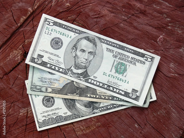 Obraz dollar notes against wooden background