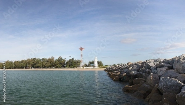 Fototapeta Lighthouse and radar transmitter. On the right is a breakwater