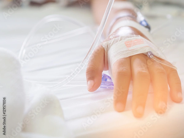 Fototapeta Saline intravenous (iv) drip on children hand in hospital. Health care and Medical equipment concept.