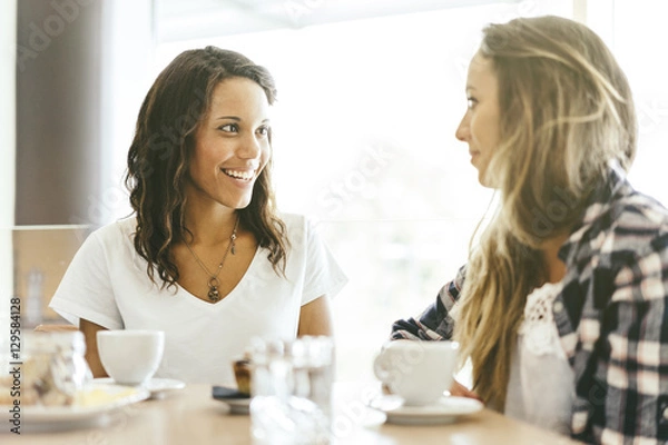 Obraz two young girls talking in a cafeteria
