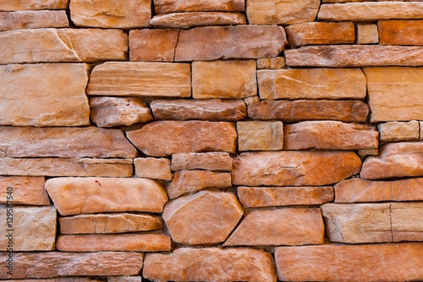 Obraz Stone brick wall background in orange color.