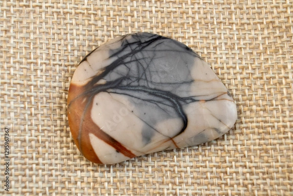 Obraz one small natural jasper picasso stone, brown and grey on craft paper background