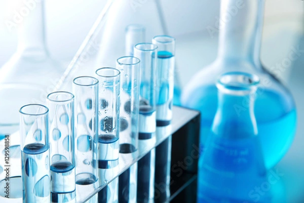 Fototapeta Different laboratory glassware with color liquid and with reflection