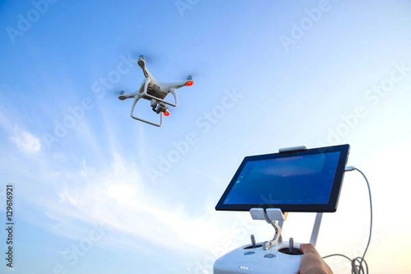 Fototapeta Quadrocopters 4 Phantom and a remote control for it. Quadrocopters against the blue sky. Umravlenie quadrocopters 4 Phantom