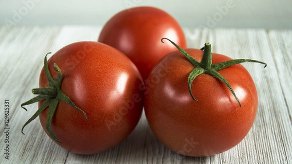 Obraz three red tomatoes on wood table