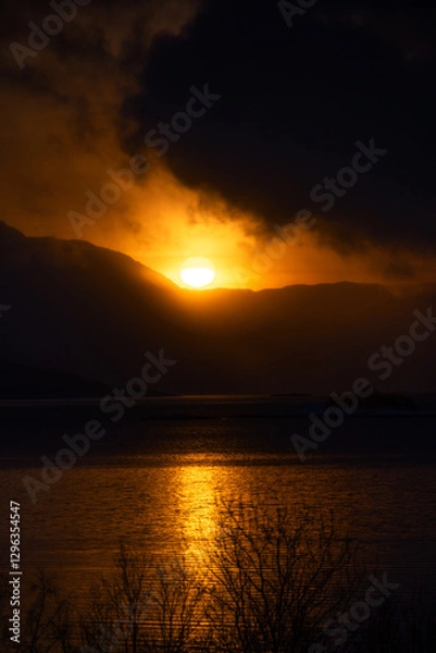 Obraz A beautiful sun shining over the snowy mountains and fjord during the first day of arctic winter. Arctic nature in Scandinavia during winter season.