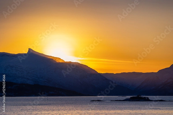 Obraz A beautiful sun shining over the snowy mountains and fjord during the first day of arctic winter. Arctic nature in Scandinavia during winter season.