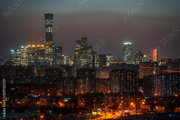 Fototapeta The night view of the city in Beijing, China, when the lights are just coming on. The high-rise buildings are ablaze with lights