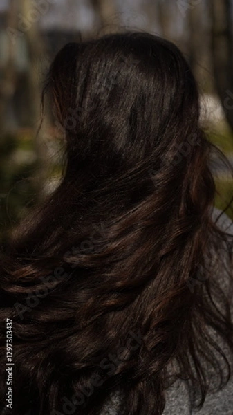 Obraz A girl with gorgeous curls and shiny hair.