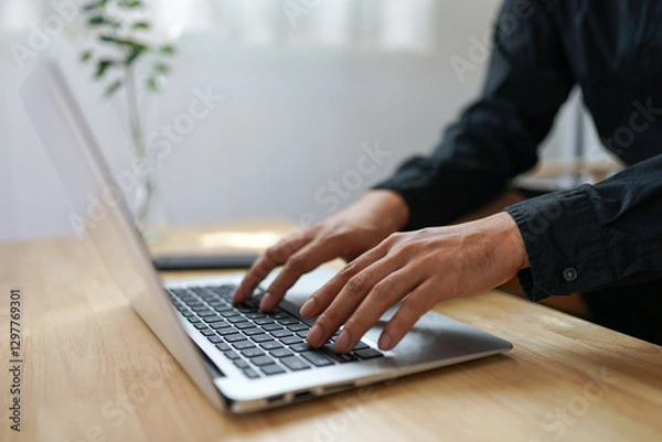 Obraz Close up view male hands writes on laptop. Entrepreneur man sit at desk work on modern wireless notebook, do remote telecommute, search information on internet, professional application usage concept
