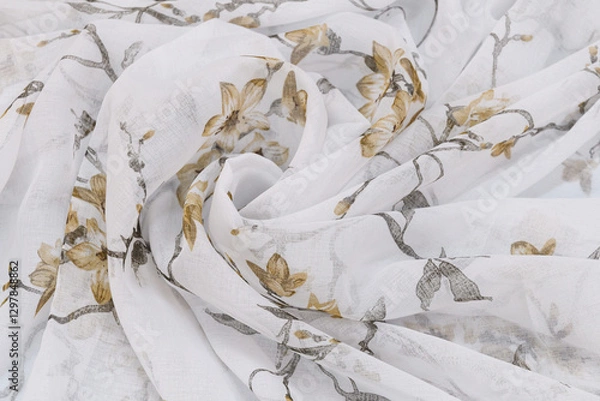Fototapeta The cloth is rolled up in waves. The background of a thin delicate tulle fabric.
