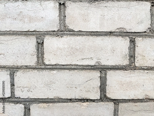 Fototapeta Rough texture of a concrete wall with cracks and irregularities. Gray tones, ideal for urban projects, backgrounds or industrial design. High quality, detail